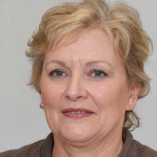 Joyful white middle-aged female with medium  brown hair and brown eyes