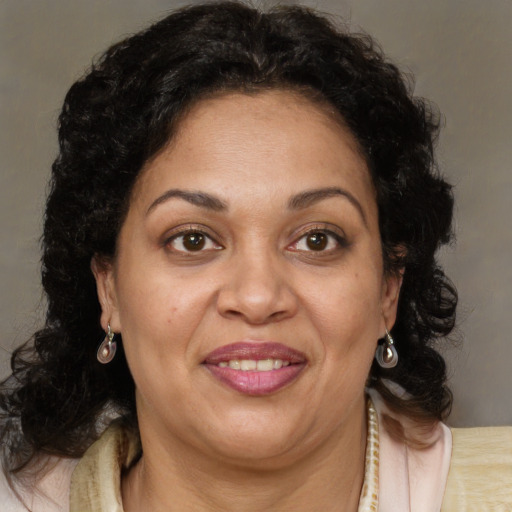 Joyful latino adult female with medium  brown hair and brown eyes