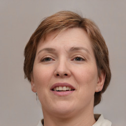 Joyful white adult female with medium  brown hair and grey eyes