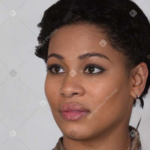 Joyful black young-adult female with short  brown hair and brown eyes