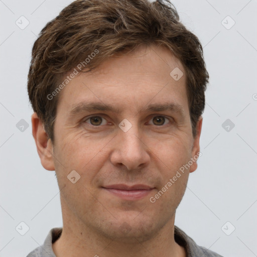 Joyful white adult male with short  brown hair and grey eyes