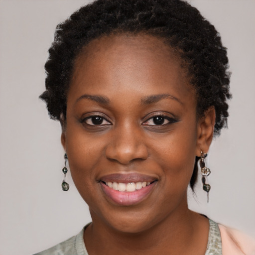 Joyful black young-adult female with short  black hair and brown eyes