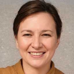 Joyful white adult female with medium  brown hair and brown eyes