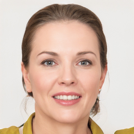 Joyful white young-adult female with medium  brown hair and grey eyes