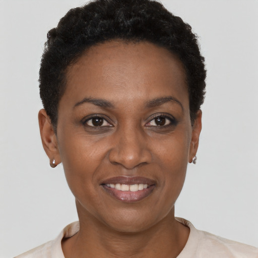 Joyful black young-adult female with short  brown hair and brown eyes