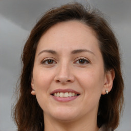 Joyful white adult female with medium  brown hair and brown eyes