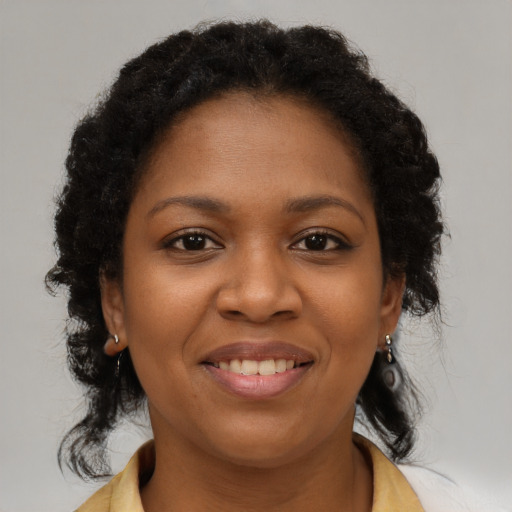 Joyful black young-adult female with medium  brown hair and brown eyes