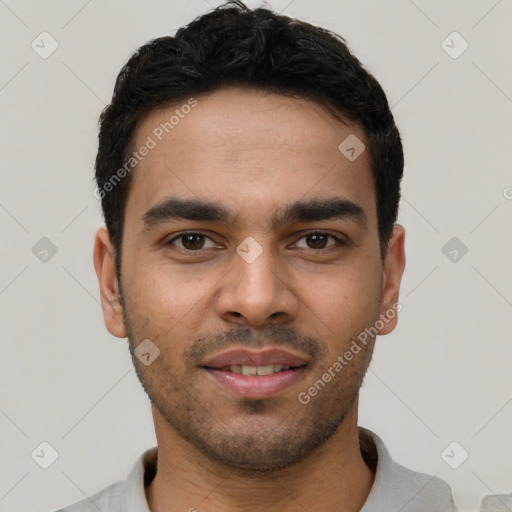 Joyful white young-adult male with short  black hair and brown eyes