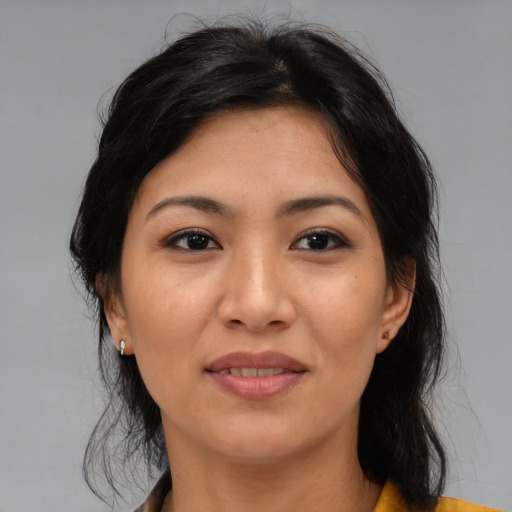 Joyful asian adult female with medium  brown hair and brown eyes