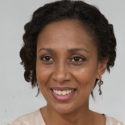 Joyful black adult female with medium  brown hair and brown eyes