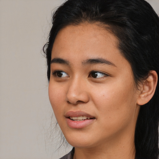 Joyful latino young-adult female with medium  black hair and brown eyes