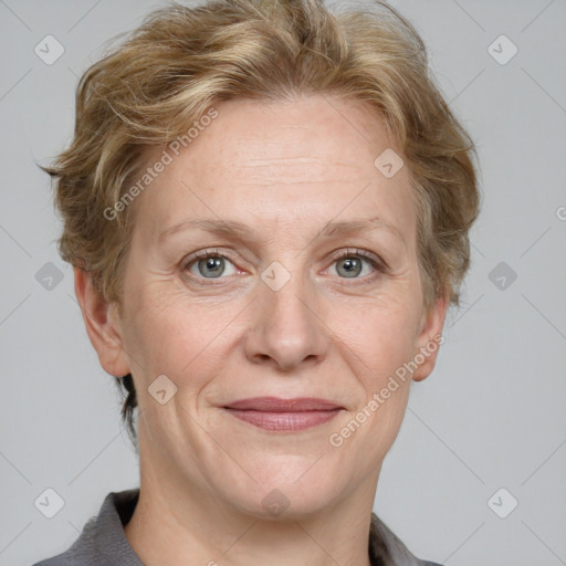 Joyful white adult female with medium  brown hair and blue eyes