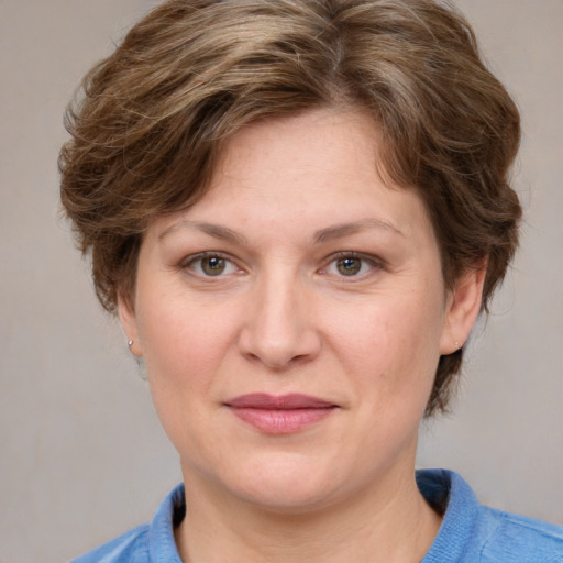 Joyful white adult female with medium  brown hair and blue eyes