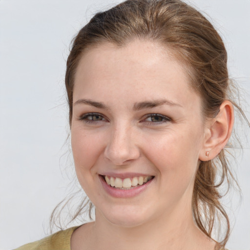 Joyful white young-adult female with medium  brown hair and grey eyes