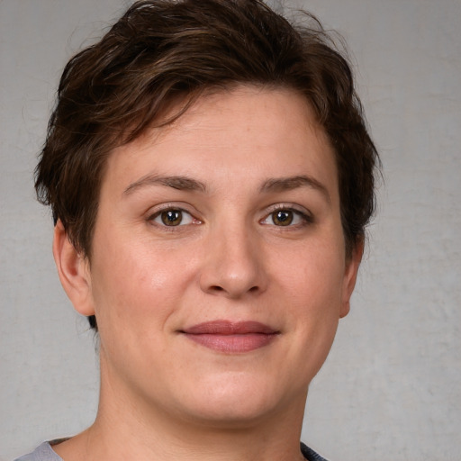 Joyful white young-adult female with short  brown hair and grey eyes