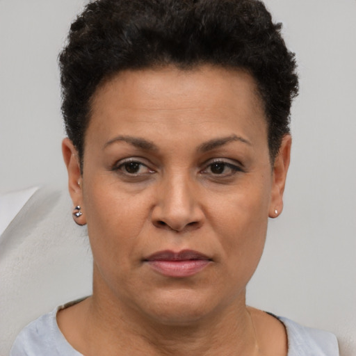 Joyful black adult female with short  brown hair and brown eyes