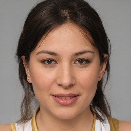 Joyful white young-adult female with medium  brown hair and brown eyes