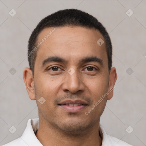 Joyful latino young-adult male with short  brown hair and brown eyes