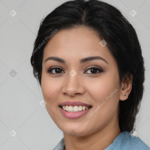 Joyful latino young-adult female with long  brown hair and brown eyes