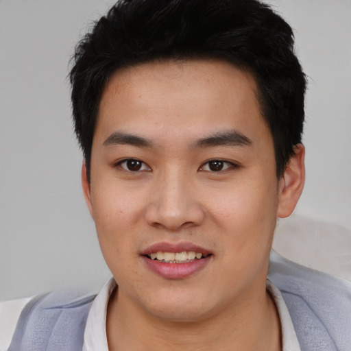 Joyful asian young-adult male with short  black hair and brown eyes