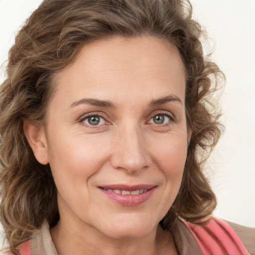 Joyful white young-adult female with medium  brown hair and green eyes