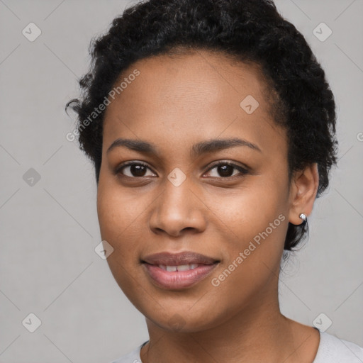 Joyful black young-adult female with short  black hair and brown eyes