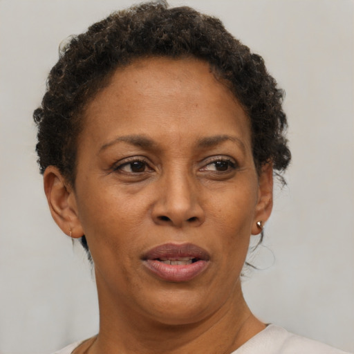 Joyful black adult female with short  brown hair and brown eyes