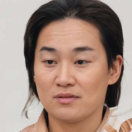 Joyful asian young-adult female with medium  brown hair and brown eyes