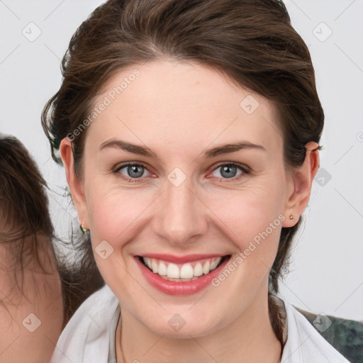 Joyful white young-adult female with medium  brown hair and blue eyes