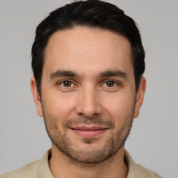 Joyful white young-adult male with short  black hair and brown eyes