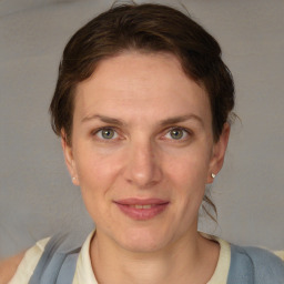 Joyful white adult female with short  brown hair and grey eyes