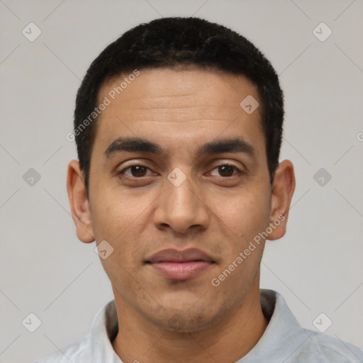 Joyful latino young-adult male with short  black hair and brown eyes