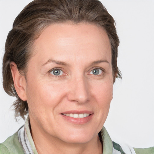 Joyful white adult female with medium  brown hair and grey eyes