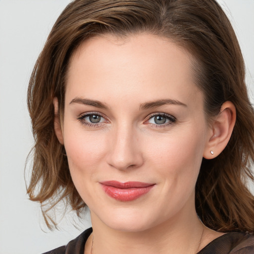 Joyful white young-adult female with medium  brown hair and blue eyes