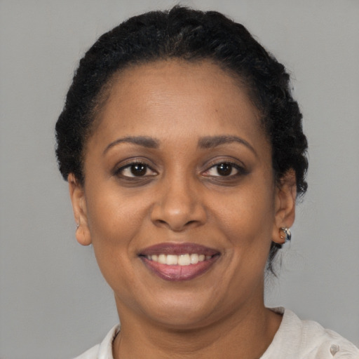 Joyful latino adult female with short  brown hair and brown eyes