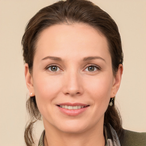 Joyful white young-adult female with medium  brown hair and brown eyes