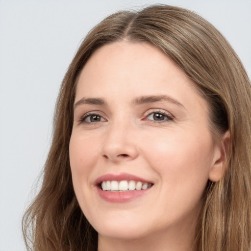 Joyful white young-adult female with long  brown hair and grey eyes