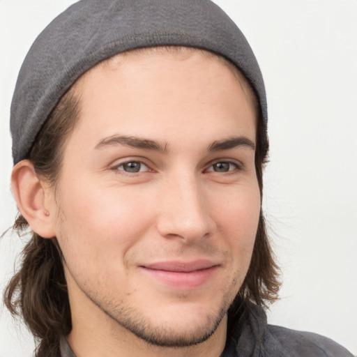 Joyful white young-adult male with medium  brown hair and brown eyes