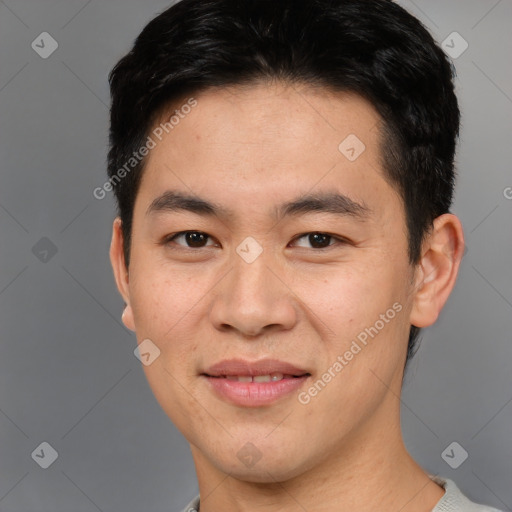 Joyful asian young-adult male with short  brown hair and brown eyes