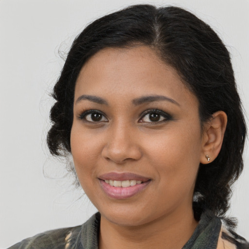 Joyful black young-adult female with medium  brown hair and brown eyes