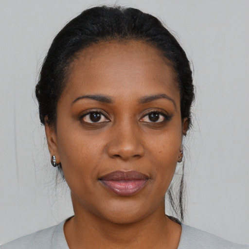 Joyful black young-adult female with medium  black hair and brown eyes