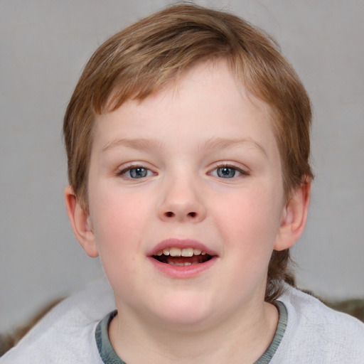 Joyful white child male with short  brown hair and blue eyes