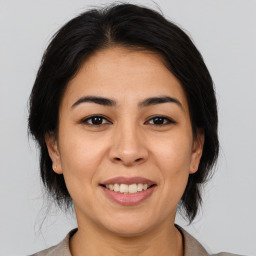 Joyful asian young-adult female with medium  brown hair and brown eyes