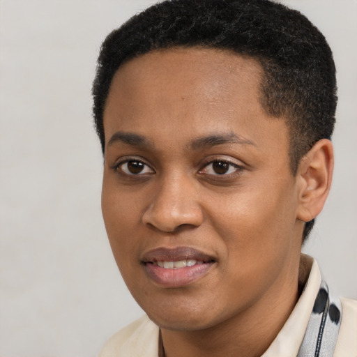 Joyful black young-adult male with short  black hair and brown eyes