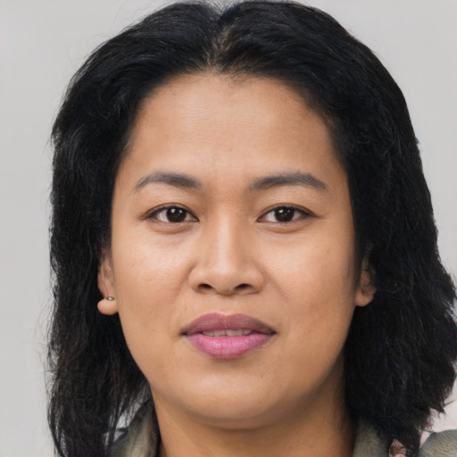 Joyful asian young-adult female with long  brown hair and brown eyes