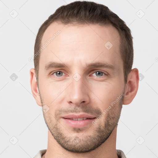 Joyful white young-adult male with short  brown hair and grey eyes