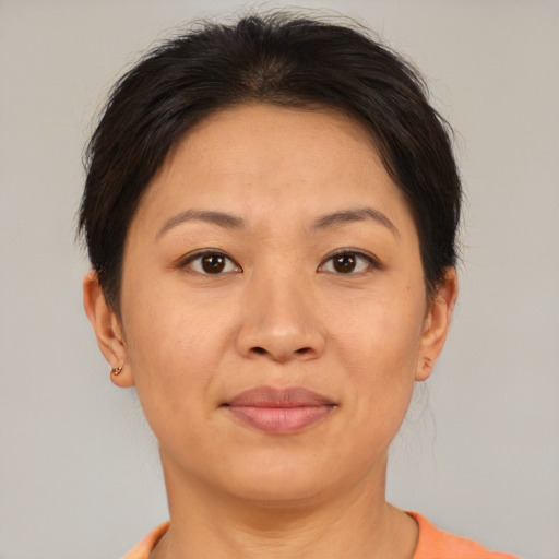 Joyful asian adult female with short  brown hair and brown eyes