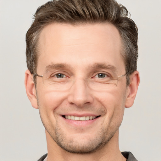 Joyful white adult male with short  brown hair and grey eyes