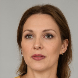 Joyful white adult female with medium  brown hair and grey eyes