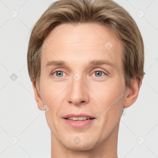 Joyful white adult male with short  brown hair and grey eyes